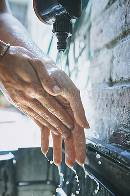 Buy stock photo Shot of an unrecognisable woman washing her hands after working with clay in a pottery studio