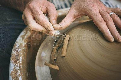 Buy stock photo Shot of an unrecognisable man working with clay in a pottery studio