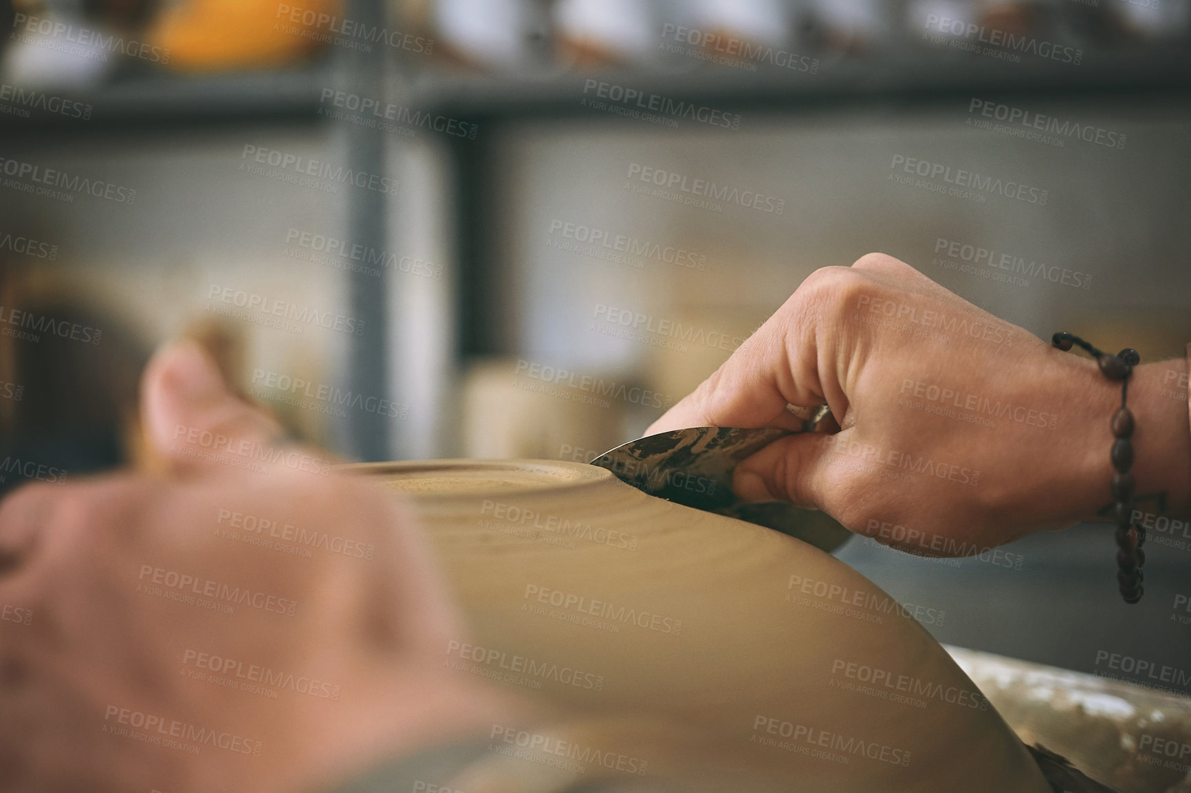 Buy stock photo Shot of an unrecognisable woman working with clay in a pottery studio