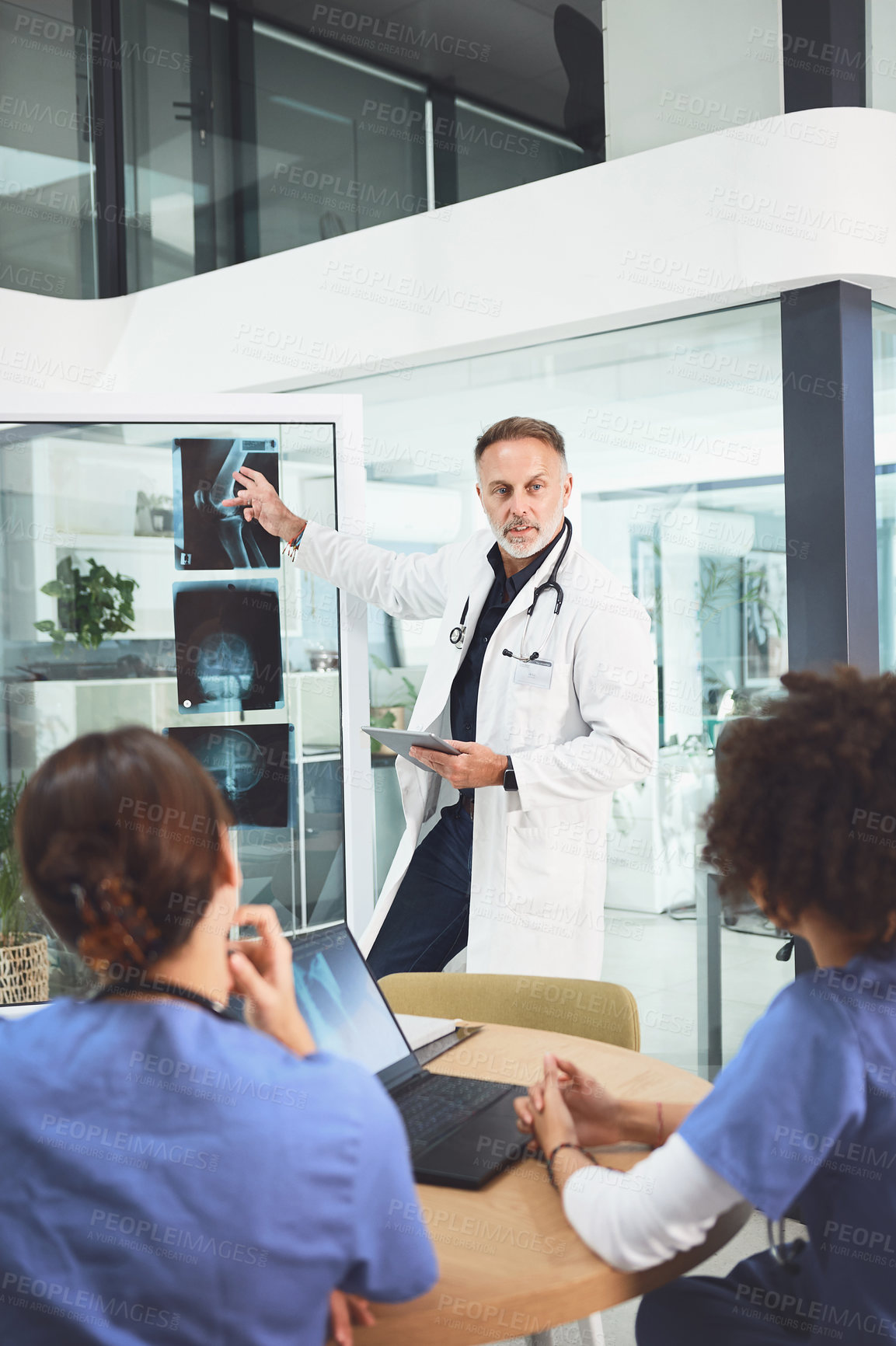 Buy stock photo Surgeon, presentation and team with xray in hospital for radiology, fracture analysis and diagnosis. Doctor, people and collaboration with mri scan, broken leg and test results and medical treatment