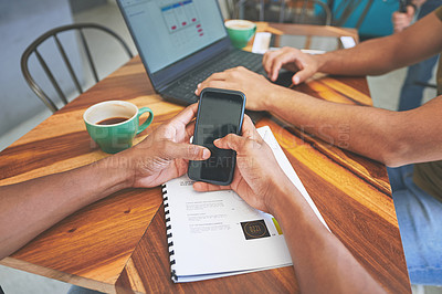 Buy stock photo Cropped shot of two unrecognizable friends sitting together and using technology in a coffeeshop