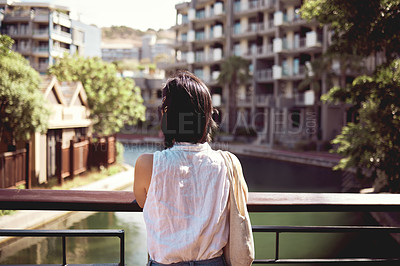 Buy stock photo Cropped shot of an unrecognizable woman exploring the city alone during the day