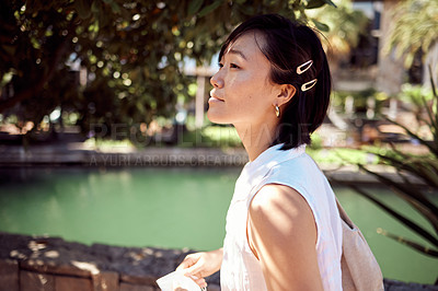 Buy stock photo Cropped shot of an attractive young woman exploring the city alone during the day