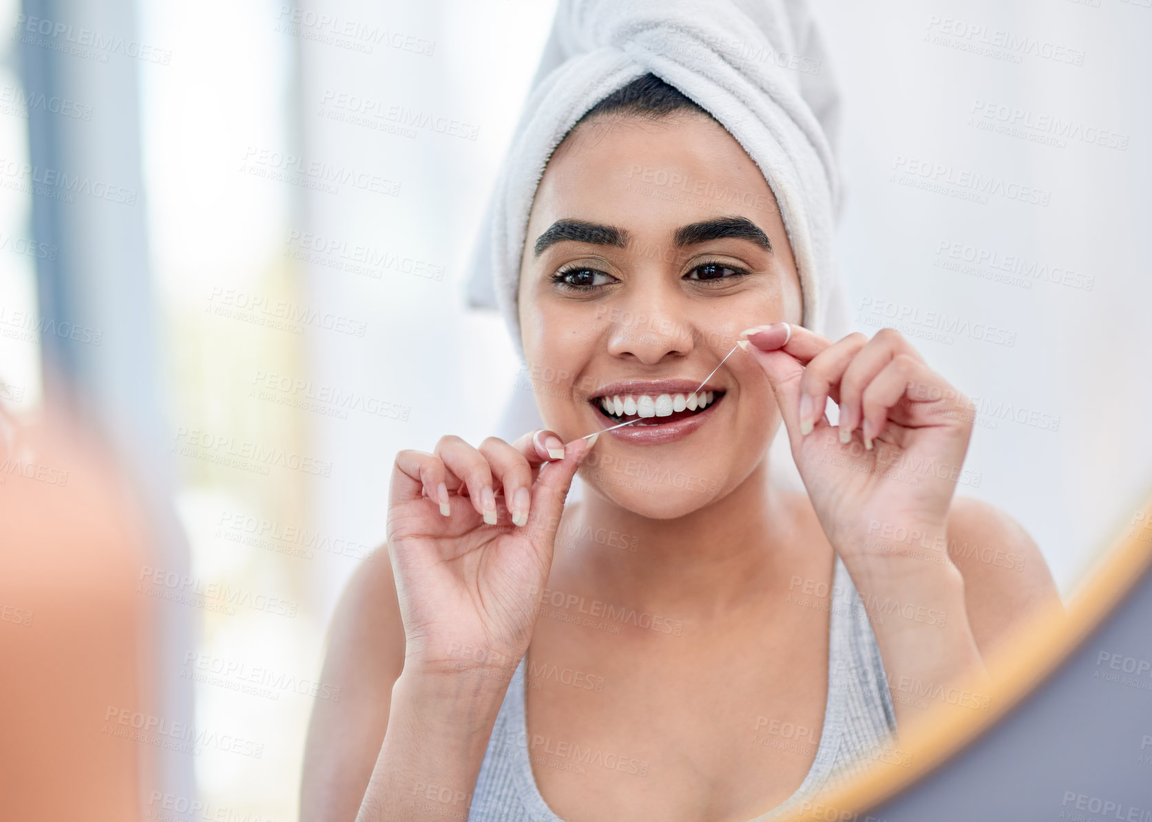 Buy stock photo Happy, woman and skincare with flossing, teeth cleaning and head towel for natural face in mirror reflection. Female model, dermatology and dental routine with smile, oral care and wellness at home