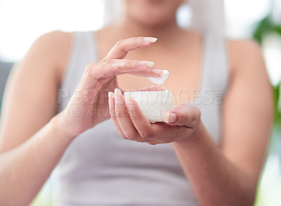 Buy stock photo Shot of woman holding a jar of cream