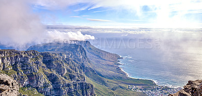 Buy stock photo Beautiful scenic landscape of Table Mountain in Cape Town, Western Cape. Aerial view of the mountain and sky covered in clouds by the ocean. Tourist attraction showing its splendor on a summer day