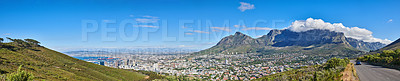 Buy stock photo Mountain landscape and panorama view of coastal city, residential buildings or infrastructure in famous travel or tourism destination. Copy space and scenic blue sky of Table Mountain in South Africa