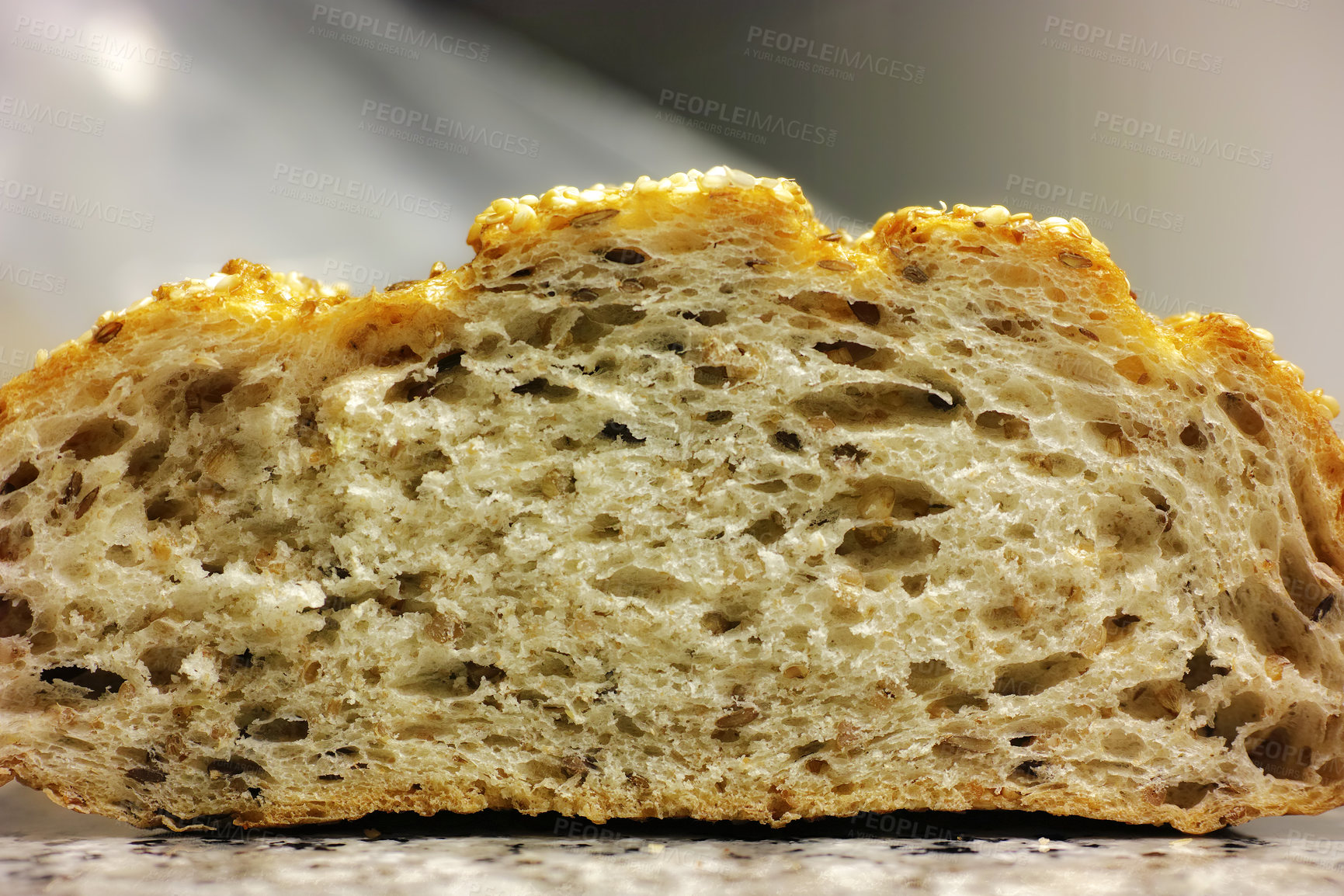 Buy stock photo Closeup of freshly baked bread in home kitchen or bakery ready to be served with balanced diet, lunch or dinner. Texture detail of delicious, homemade and gourmet wheat or rye product for sandwiches