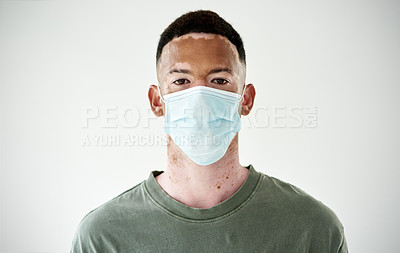 Buy stock photo Man, studio or face mask for covid 19 in portrait with melasma, prevention for corona or disease. Male model or backdrop with vitiligo and safety for virus, person with skin pigmentation in Indonesia