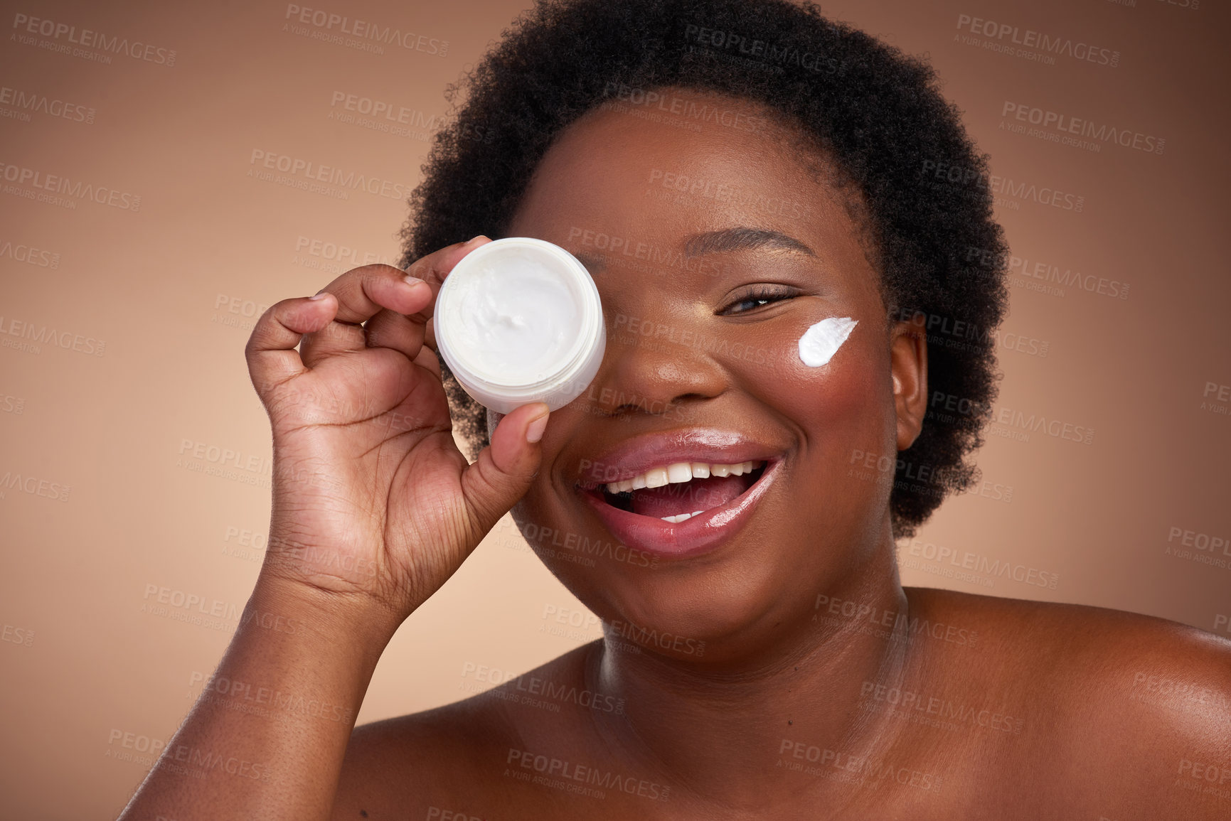 Buy stock photo Studio portrait of a beautiful young woman looking happy against a brown background