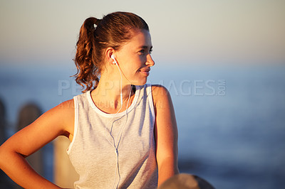 Buy stock photo Fitness, thinking and woman with earphones at ocean, nature and exercise for health. Music, audio and marathon training for cardio workout for female athlete, endurance and break by water for breathe