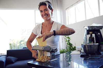 Buy stock photo Prepare, pasta and portrait of woman in kitchen with dough for spaghetti, ingredients and gourmet meal in home. Cooking, food and female person with machine for handmade, dinner or recipe in house