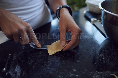 Buy stock photo Cropped shot of an unrecognizable young woman cooking homemade pasta at home