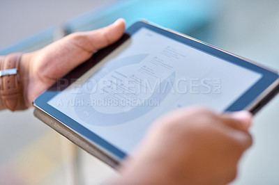 Buy stock photo Cropped shot of an unrecognizable businessman standing alone and holding a digital tablet during the day