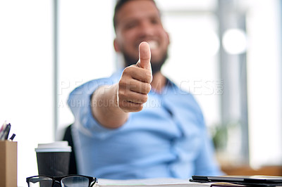 Buy stock photo Cropped shot of an unrecognizable businessman sitting alone in his office and making a thumbs up gesture in approval