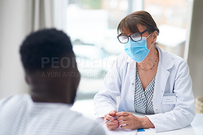 Buy stock photo Shot of a female doctor speaking to a patient in her office