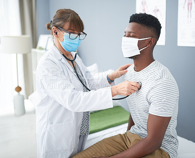 Buy stock photo Shot of a female doctor giving a male patient a check up