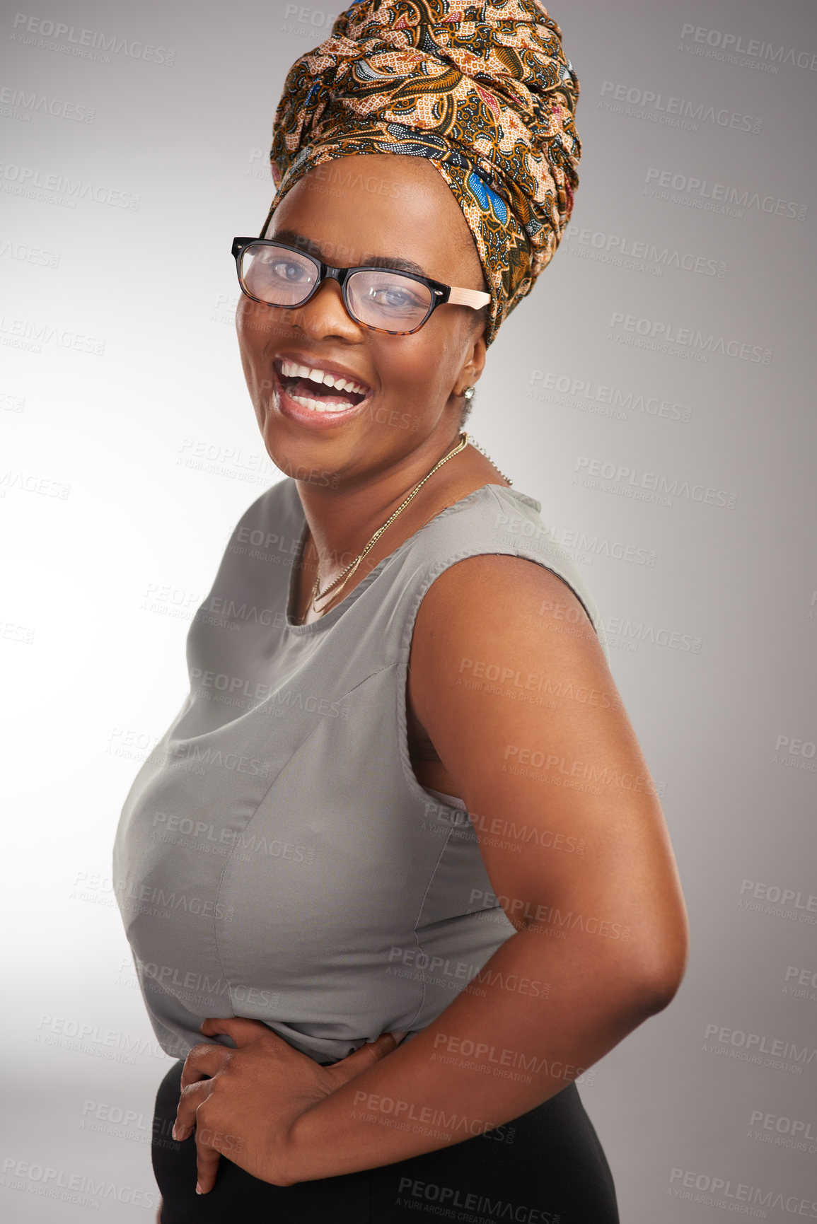 Buy stock photo Cropped portrait of an attractive young woman standing alone in the studio during the day