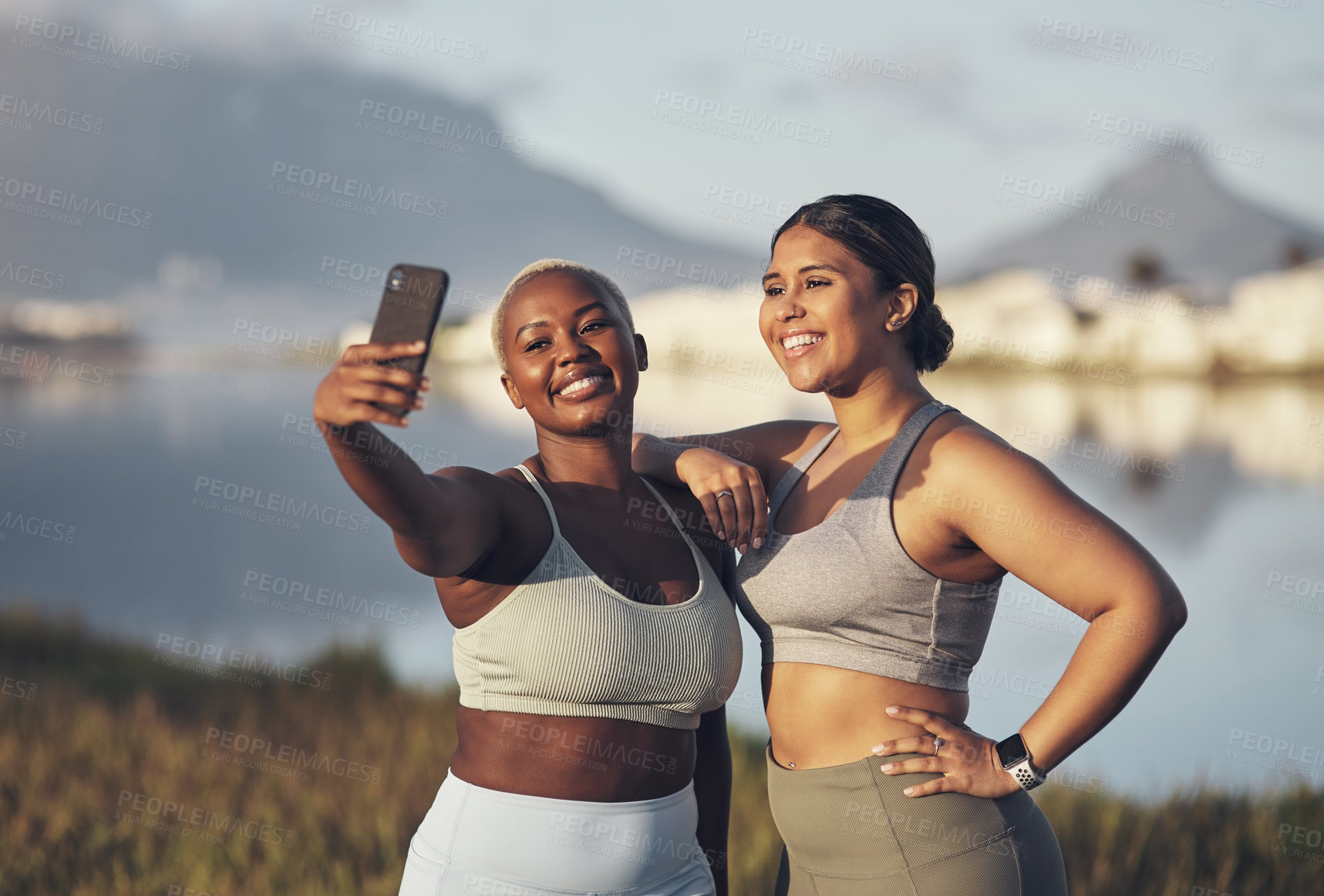 Buy stock photo Shot of two women taking a selfie while out for a run
together