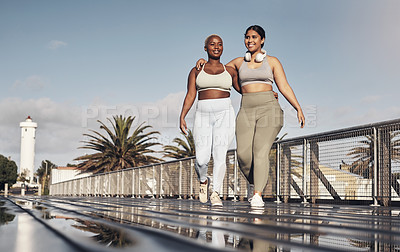 Buy stock photo Shot of two young women out for a run together