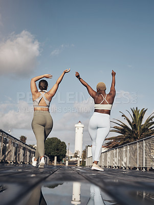 Buy stock photo Shot of two young women looking cheerful while out for a workout