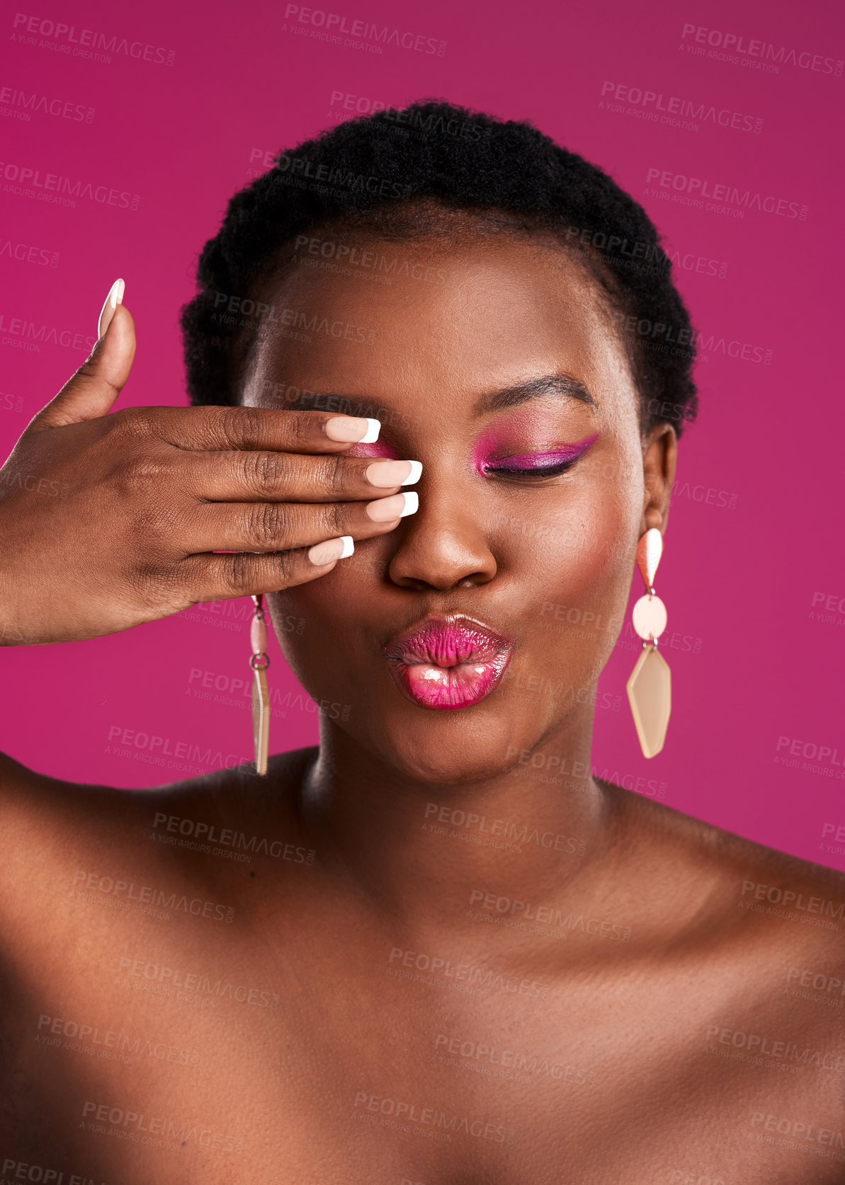 Buy stock photo Studio shot of a beautiful young woman covering her eye against a pink background