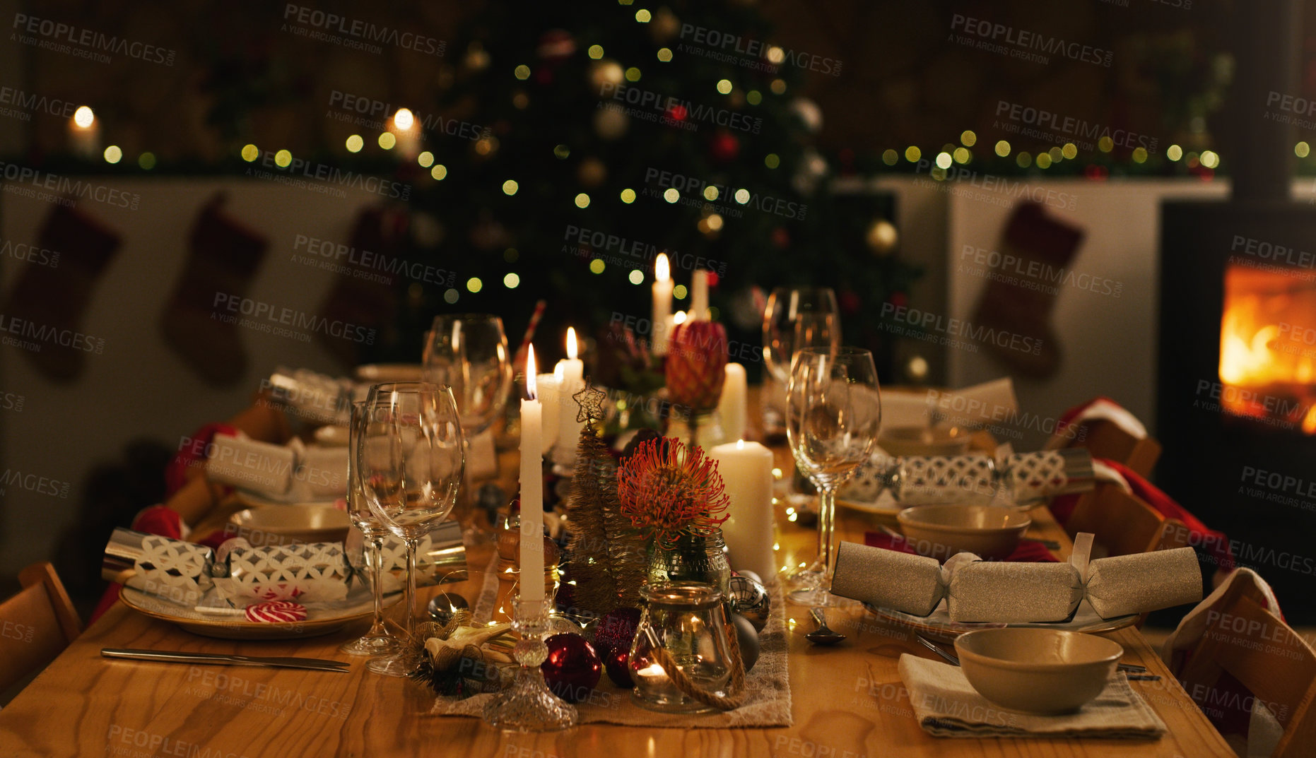 Buy stock photo Shot of a neatly arranged dinner table and Christmas tree ahead of a family Christmas dinner at home