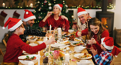 Buy stock photo Shot of a happy family having Christmas lunch together at home