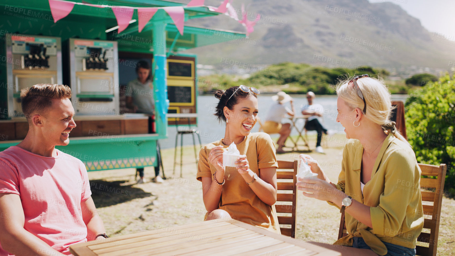 Buy stock photo Happy, friends and eating ice cream at outdoor table of restaurant, speaking or funny group bonding. Gelato, people and laughing together in nature for comedy or gossip story by food truck in summer