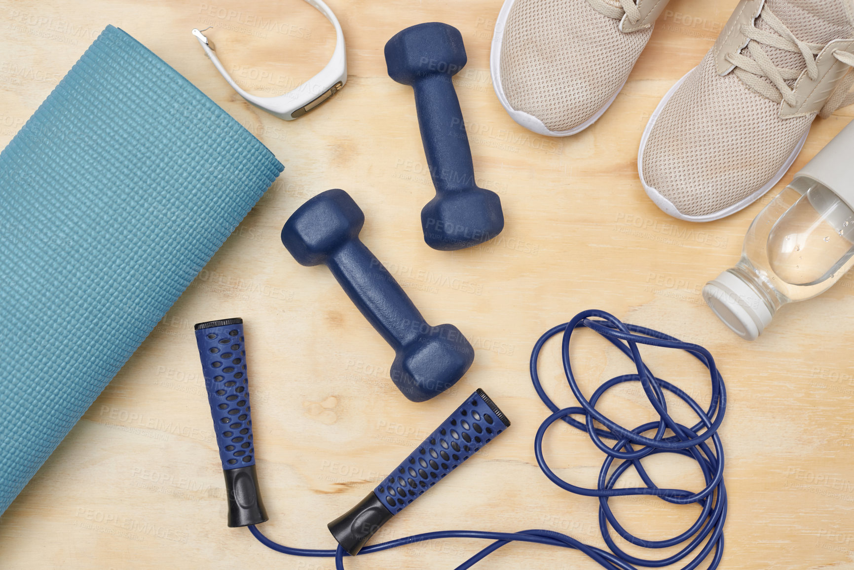 Buy stock photo Studio shot of a variety of workout equipment on a wooden floor