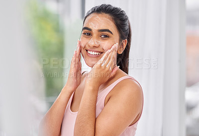 Buy stock photo Cropped shot of a young woman washing her face in the bathroom