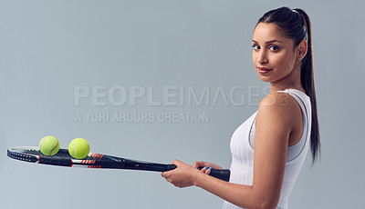 Buy stock photo Cropped portrait of an attractive young female tennis player posing against a grey background in studio