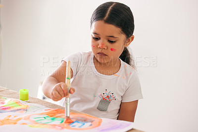 Buy stock photo Shot of an adorable little girl painting while sitting at a table