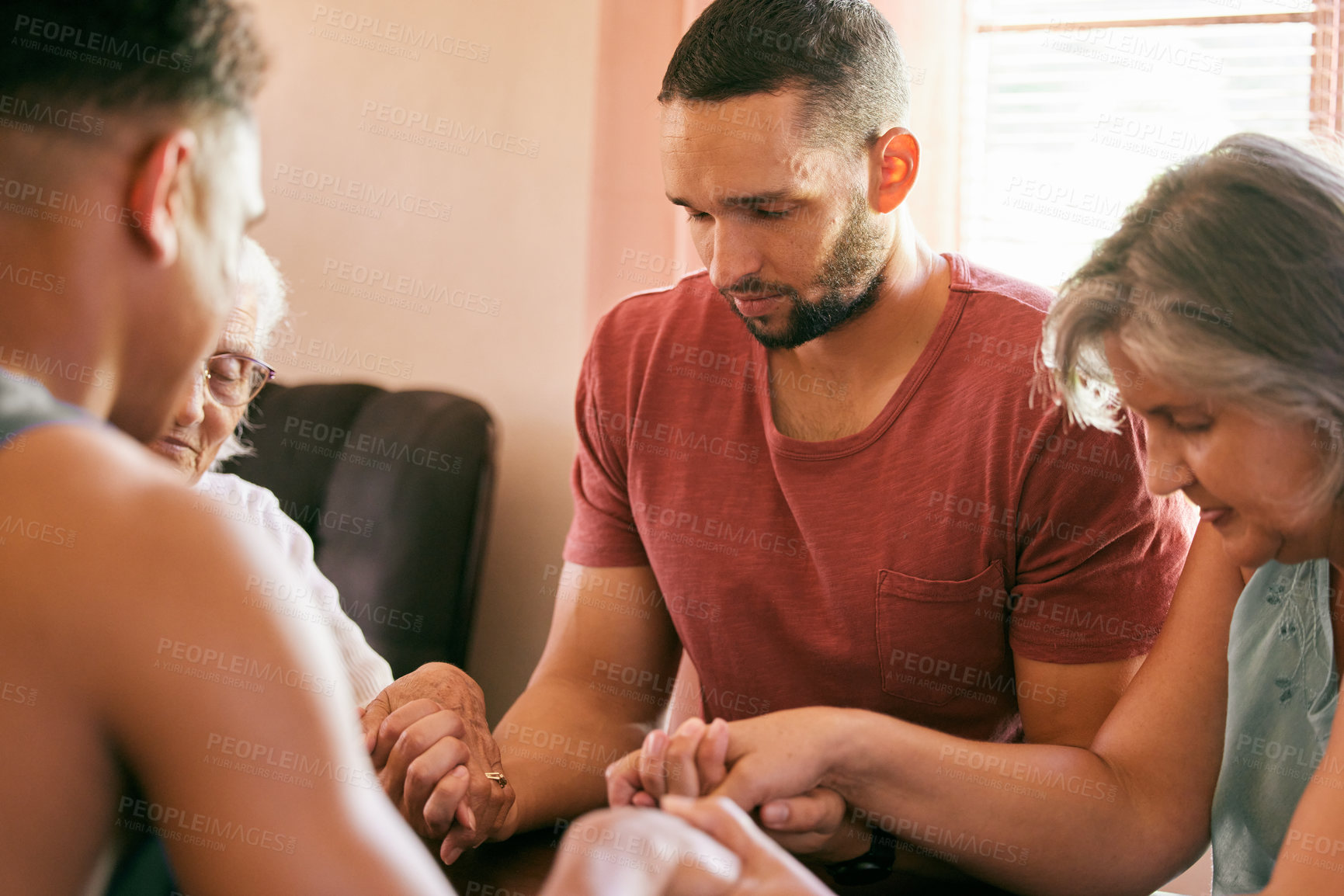 Buy stock photo Shot of a family holding hands with eyes closed in prayer