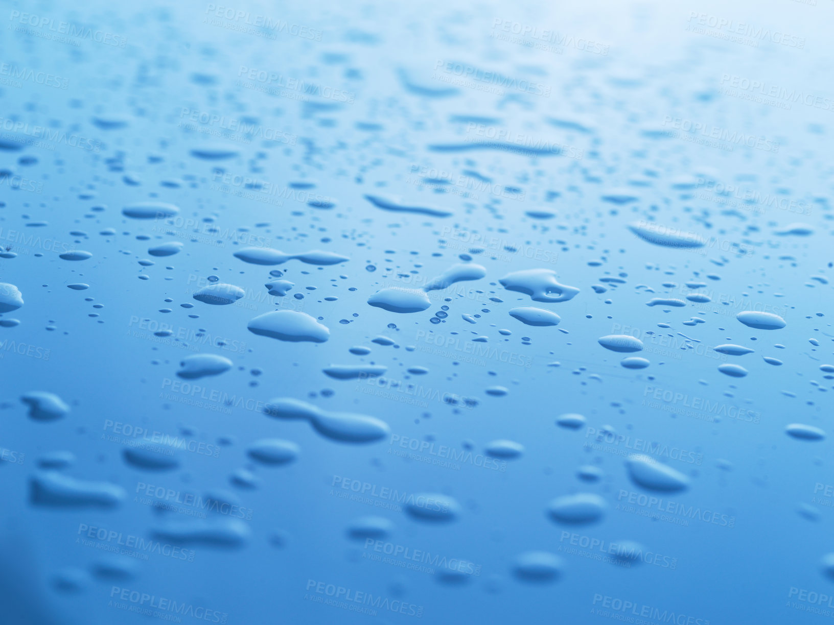 Buy stock photo Copy space and closeup of water raindrops or condensation forming on smooth blue surface after rainfall or shower. Texture detail or background of fresh, hydrating liquid after cooled steam or vapour