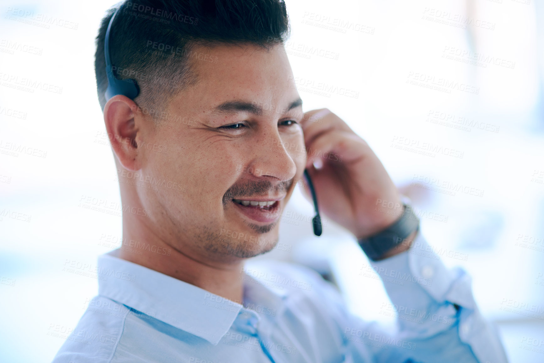 Buy stock photo Shot of a young man using a headset in a modern office