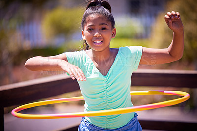 Buy stock photo Happy girl, portrait and playing with plastic hoop at park for fun game, activity or outdoor exercise. Young teenager or female person with smile for hula practice, twist or motion at playground