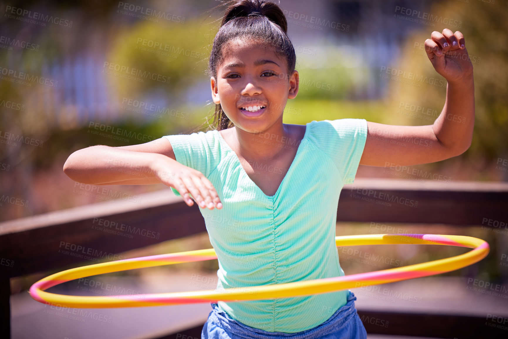 Buy stock photo Happy girl, portrait and playing with plastic hoop at park for fun game, activity or outdoor exercise. Young teenager or female person with smile for hula practice, twist or motion at playground