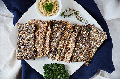 Buy stock photo Overhead shot of seed crackers on a white serving plate