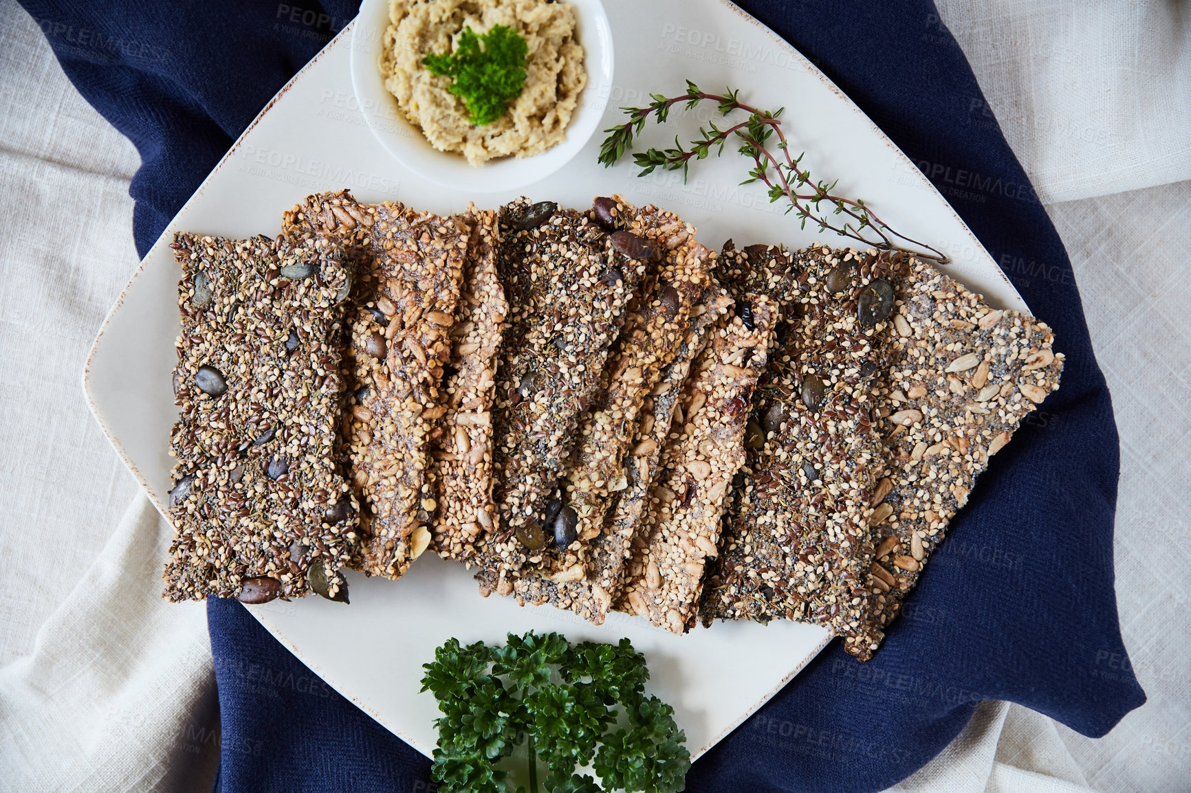 Buy stock photo Overhead shot of seed crackers on a white serving plate