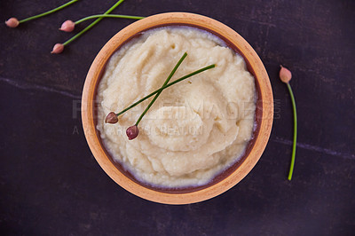 Buy stock photo Overhead shot of cauliflower mash puree in a wooden bowl on a black table