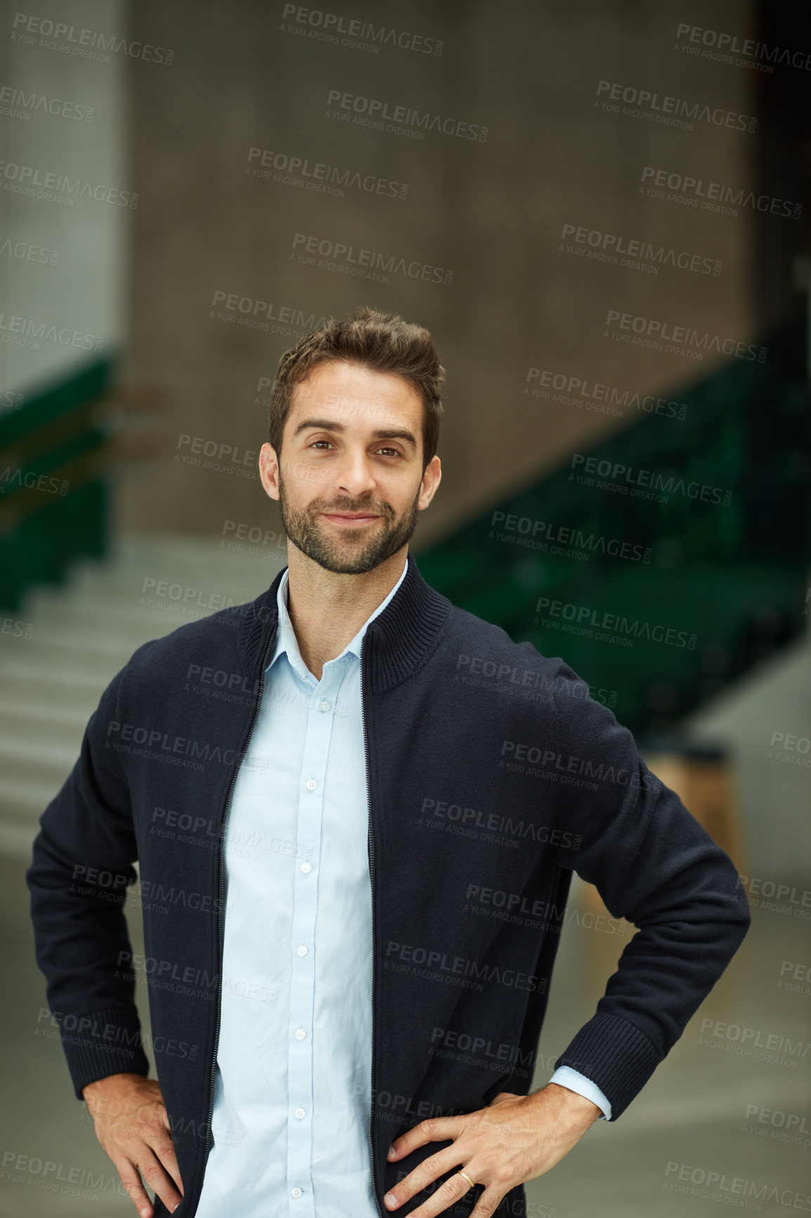 Buy stock photo Cropped portrait of a handsome young businessman standing alone in an office space during the day