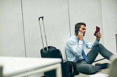 Buy stock photo Cropped shot of a handsome young businessman sitting in an airport terminal and using his cellphone while holding his passport