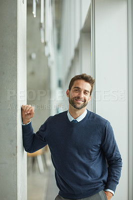 Buy stock photo Cropped portrait of handsome young businessman standing indoors alone during the day