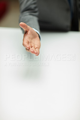 Buy stock photo Cropped shot of an unrecognizable businessman standing alone and extending his hand for a handshake