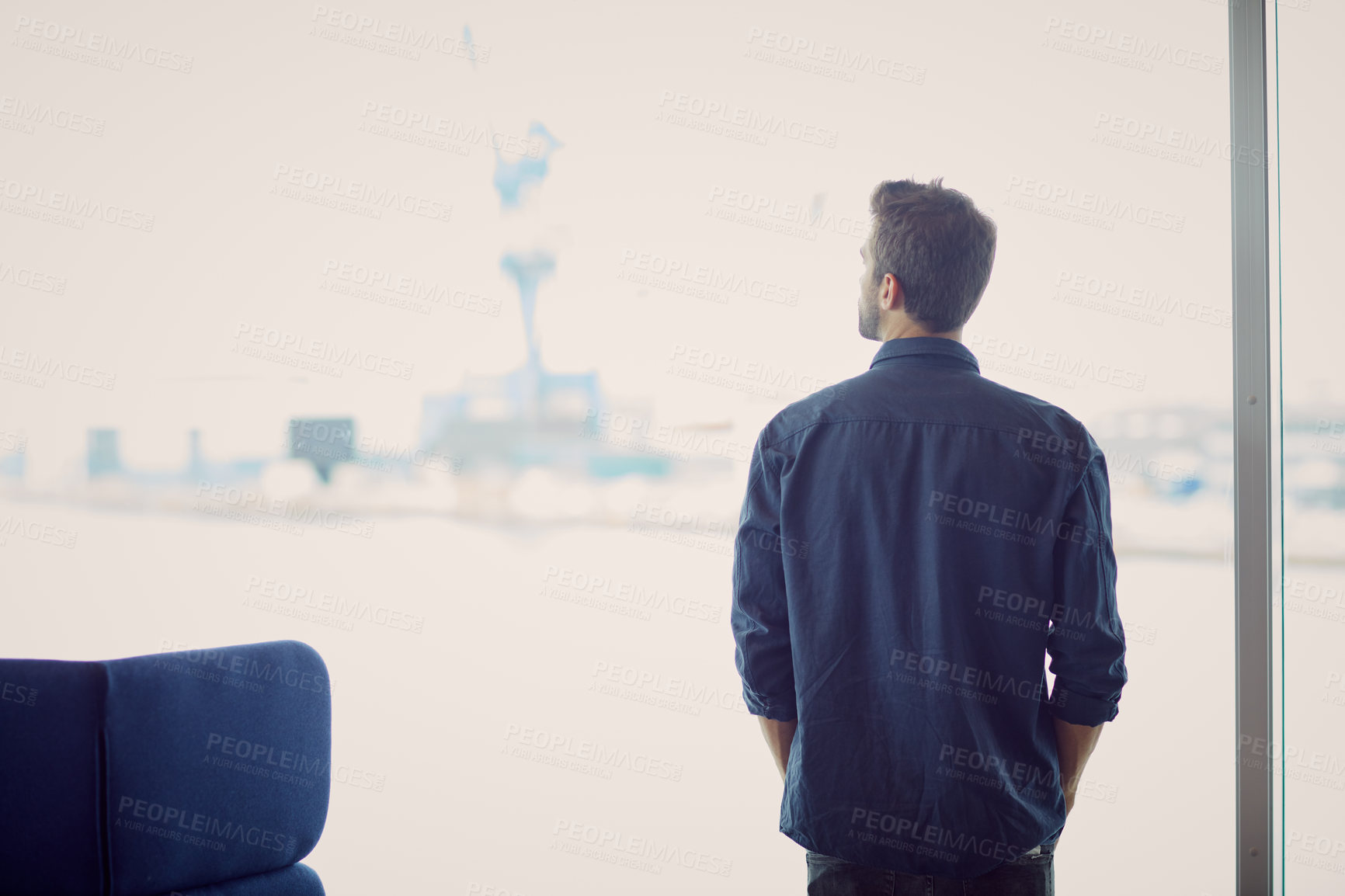 Buy stock photo Cropped shot of an unrecognizable businessman standing alone in an airport terminal during the day