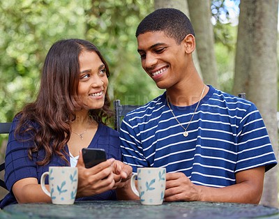 Buy stock photo Shot of a young couple on a date at a outdoor cafe
