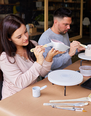 Buy stock photo Couple, date and painting ceramics for creativity, art workshop for bonding with paintbrush and material. Anniversary activity, craft and people at pottery lesson with watercolor for clay bowl