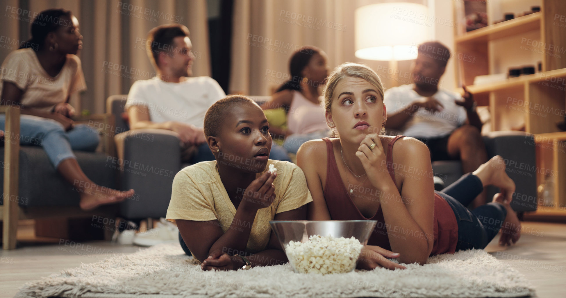 Buy stock photo Friends, popcorn and movie at home at night for entertainment and relaxing for enjoyment. Friend, together and watching tv in the lounge with a snack in the evening to relax on the weekend for fun.