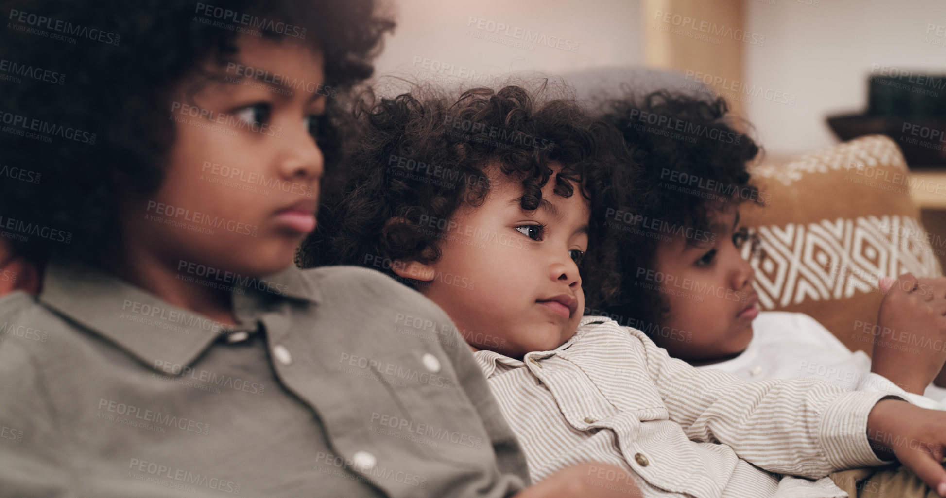 Buy stock photo Shot of three adorable little boys watching movies together at home